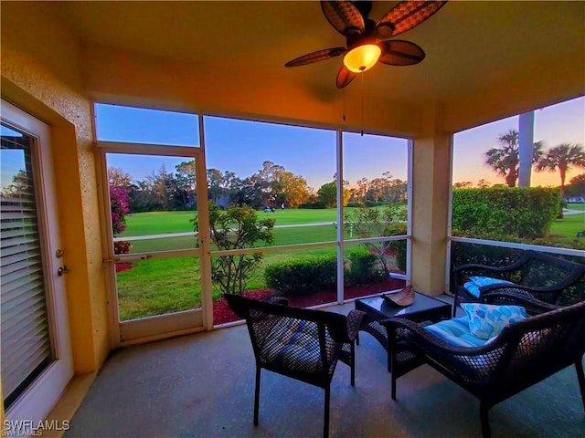 sunroom / solarium featuring ceiling fan