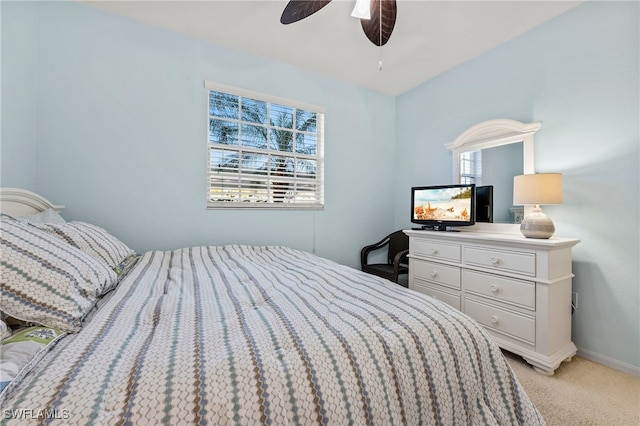 bedroom with light colored carpet, baseboards, and ceiling fan