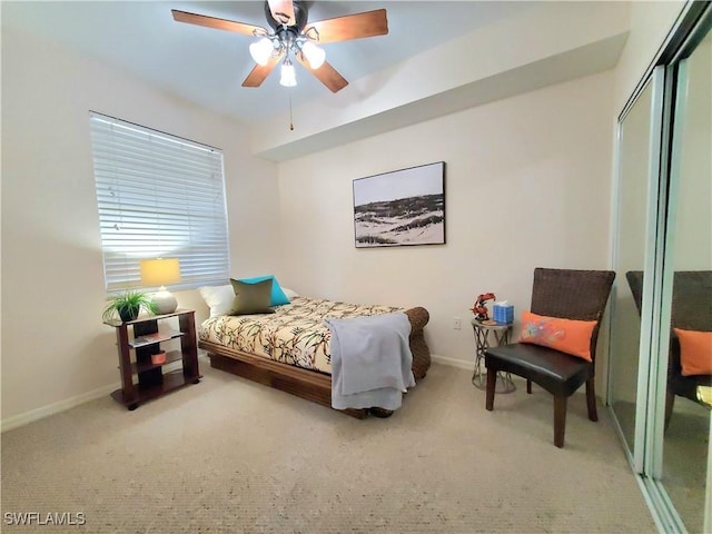 carpeted bedroom with baseboards, a closet, and ceiling fan