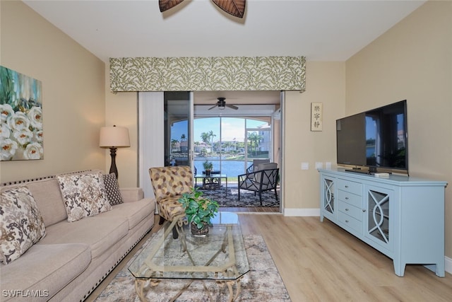 living room with ceiling fan and light hardwood / wood-style flooring