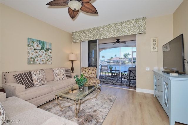 living room with light wood-type flooring and ceiling fan