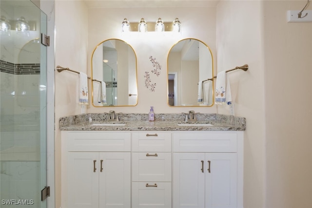 bathroom featuring an enclosed shower and vanity