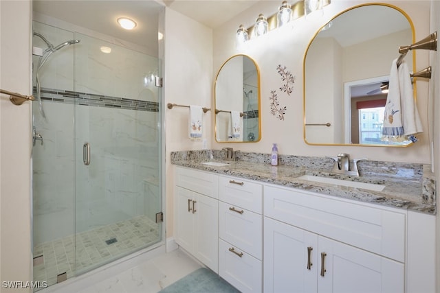 bathroom featuring walk in shower and vanity