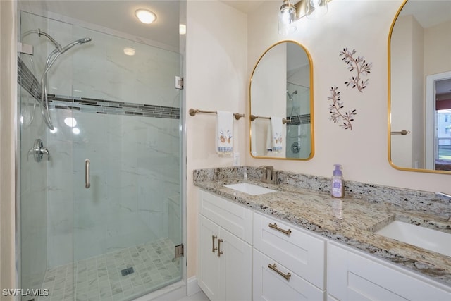 bathroom featuring vanity and a shower with door