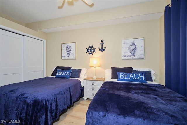 bedroom with ceiling fan, light hardwood / wood-style floors, and a closet