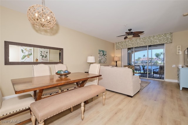 dining area featuring ceiling fan with notable chandelier and light hardwood / wood-style flooring