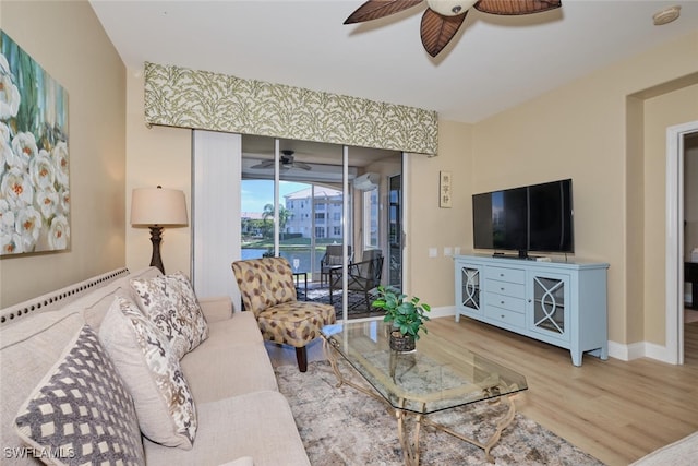 living room with wood-type flooring and ceiling fan