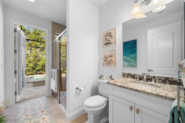 bathroom with tile patterned floors, toilet, a shower with door, and vanity