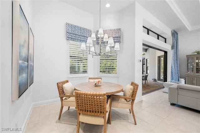 dining room with crown molding, light tile patterned floors, and a chandelier