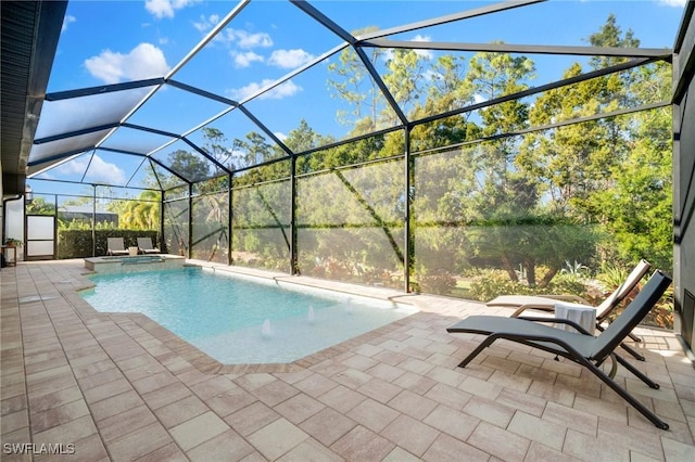 view of pool with a patio, an in ground hot tub, and glass enclosure