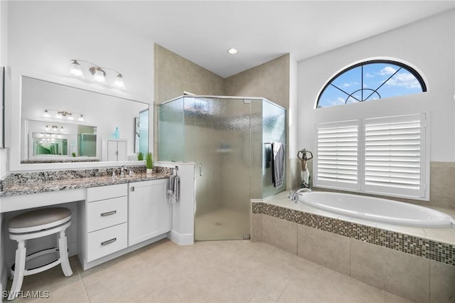 bathroom with shower with separate bathtub, tile patterned floors, and vanity