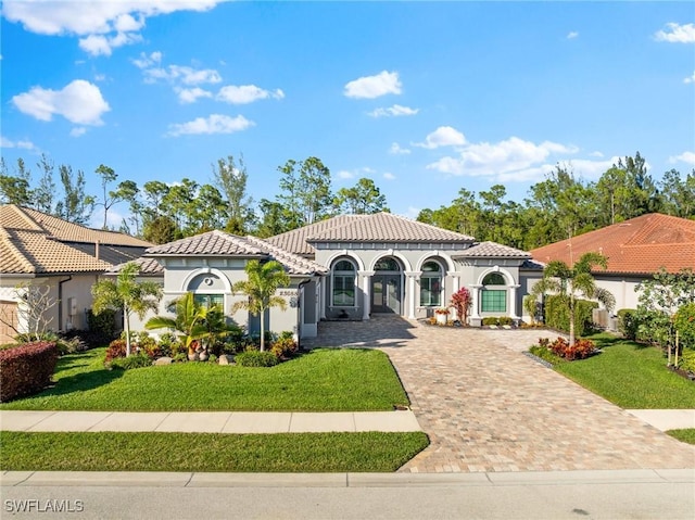 mediterranean / spanish-style house featuring a front yard