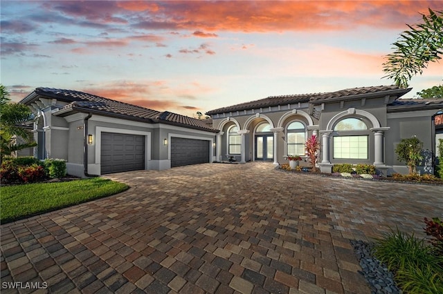 mediterranean / spanish home featuring a garage