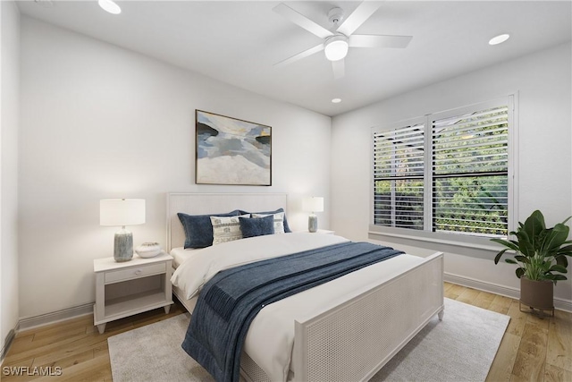 bedroom with ceiling fan and light hardwood / wood-style floors