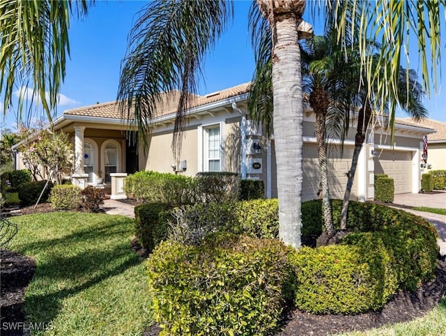 mediterranean / spanish home featuring a front lawn