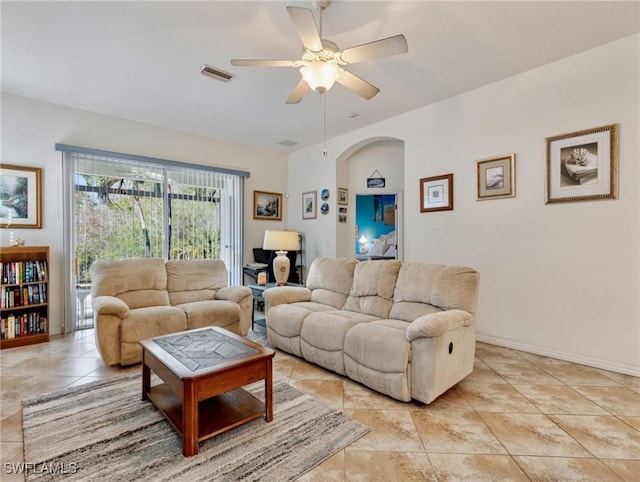 tiled living room featuring ceiling fan