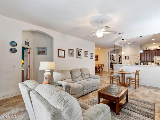 living room featuring light tile patterned floors and ceiling fan