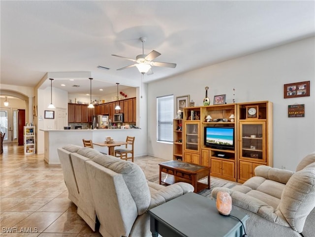 tiled living room featuring ceiling fan