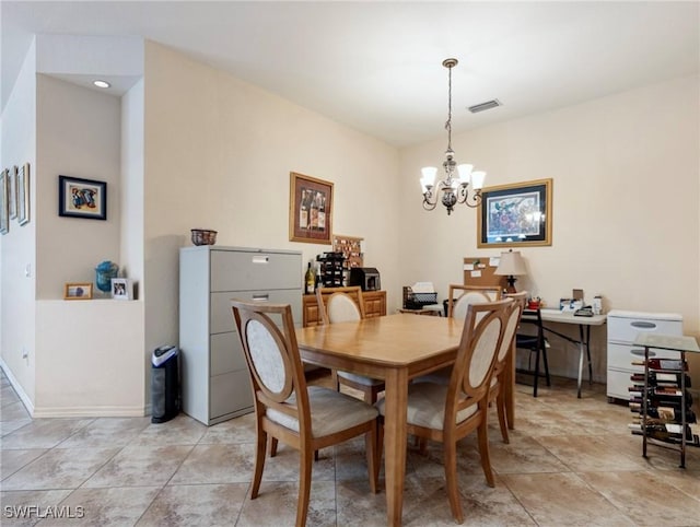 dining room featuring a notable chandelier and light tile patterned floors