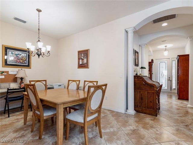 dining space featuring a notable chandelier and decorative columns