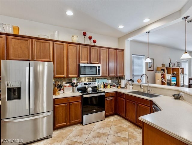 kitchen with sink, backsplash, stainless steel appliances, and hanging light fixtures