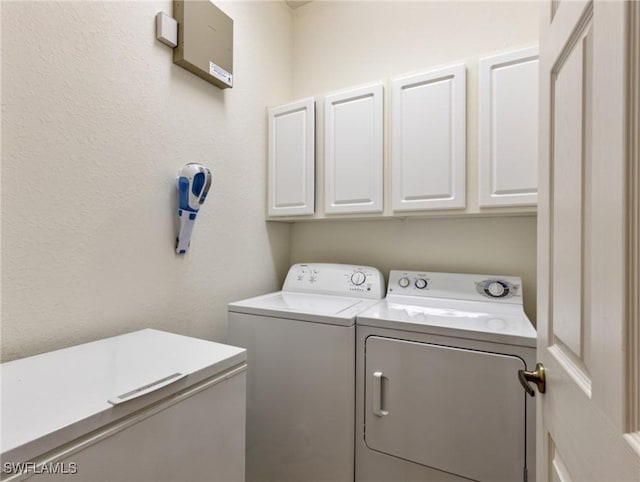 laundry area featuring cabinets and separate washer and dryer