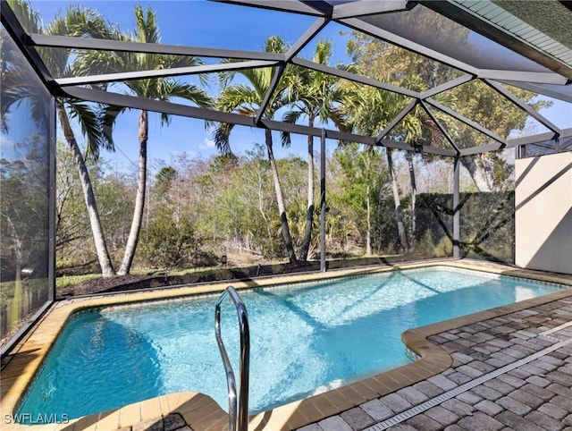 view of pool featuring a patio and glass enclosure