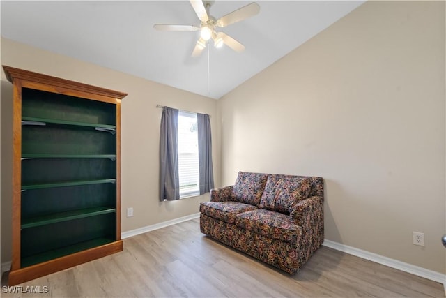 sitting room with hardwood / wood-style flooring, ceiling fan, and vaulted ceiling