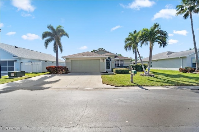 ranch-style home featuring a garage and a front yard