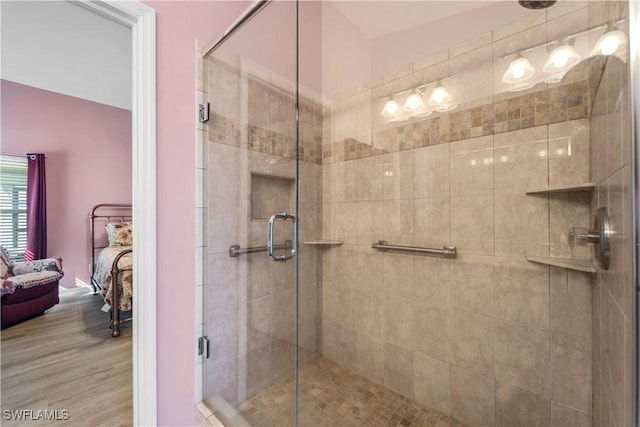 bathroom with hardwood / wood-style flooring and walk in shower