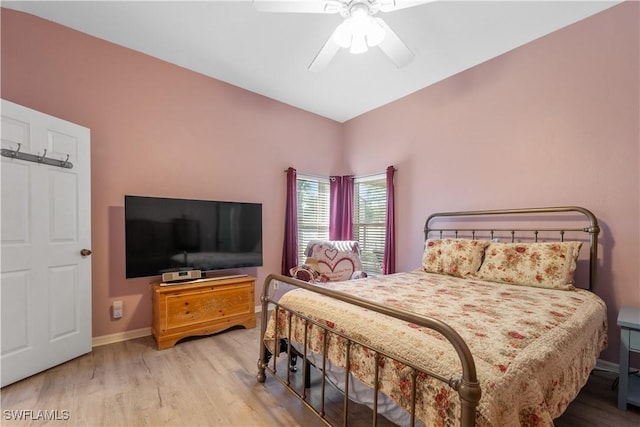 bedroom with light hardwood / wood-style flooring and ceiling fan