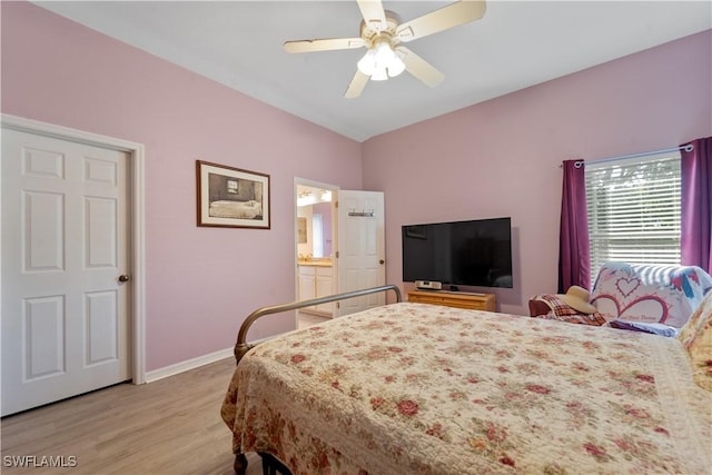 bedroom with ceiling fan, lofted ceiling, light hardwood / wood-style floors, and ensuite bath