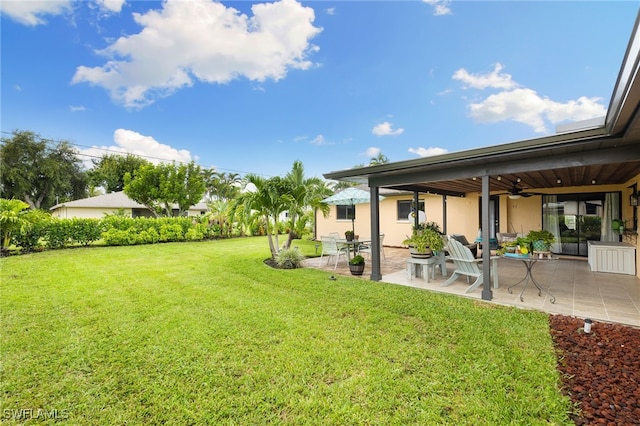 view of yard featuring a patio and ceiling fan