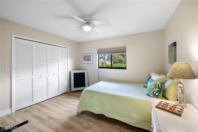 bedroom with a closet, ceiling fan, and light hardwood / wood-style flooring