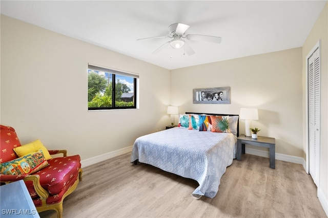 bedroom with ceiling fan, a closet, and light hardwood / wood-style flooring