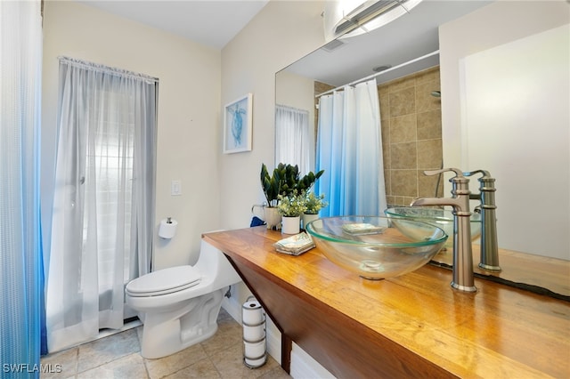 bathroom featuring toilet, tile patterned floors, and vanity