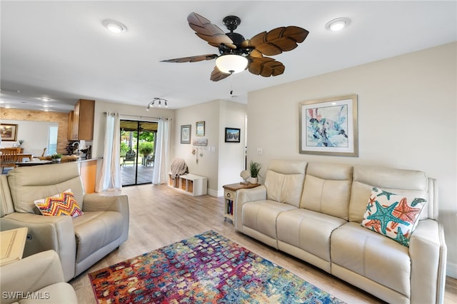 living room with light hardwood / wood-style floors and ceiling fan