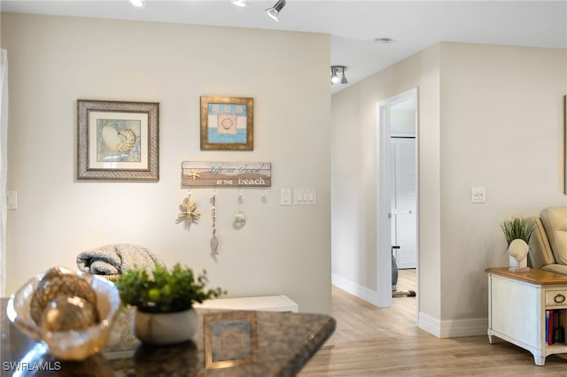 corridor with light hardwood / wood-style flooring