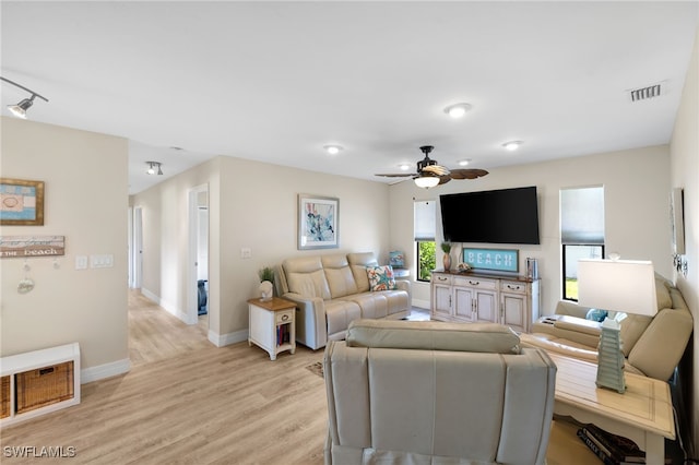 living room with light hardwood / wood-style flooring and ceiling fan