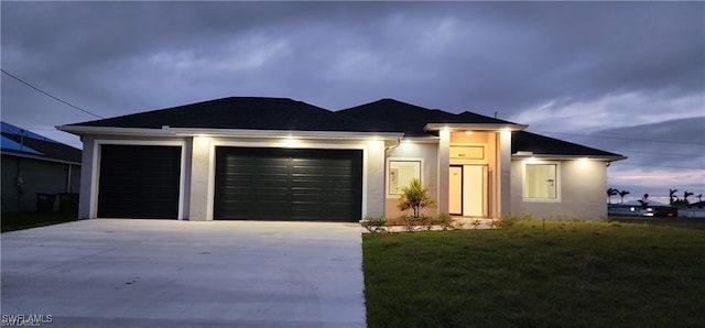 view of front facade with a garage and a front yard