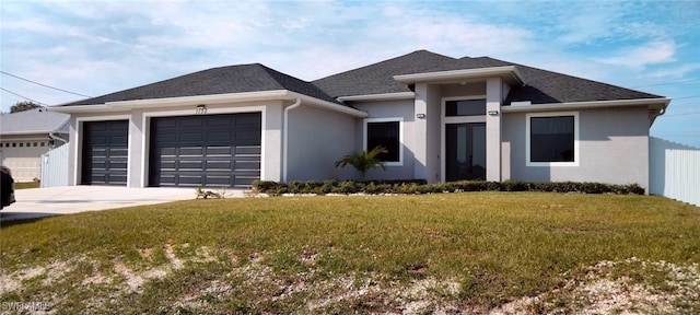 view of front facade with a garage and a front lawn