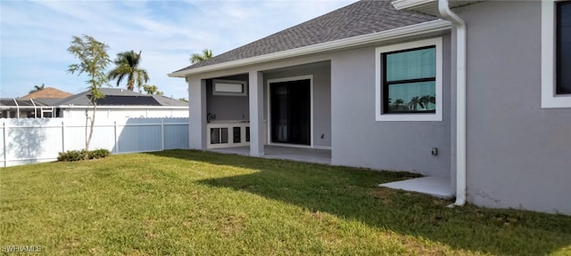 rear view of property featuring a yard