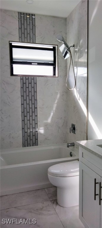 full bathroom featuring vanity, toilet, and tiled shower / bath