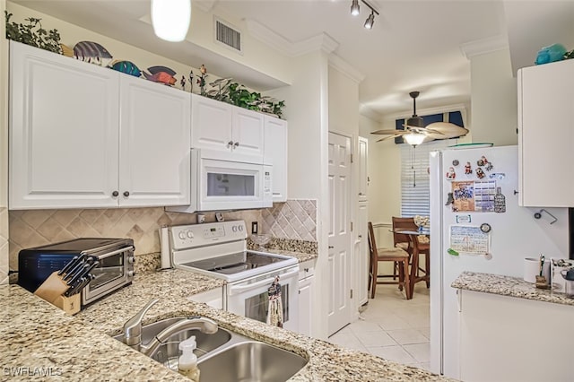 kitchen with white appliances, decorative backsplash, sink, white cabinets, and ornamental molding