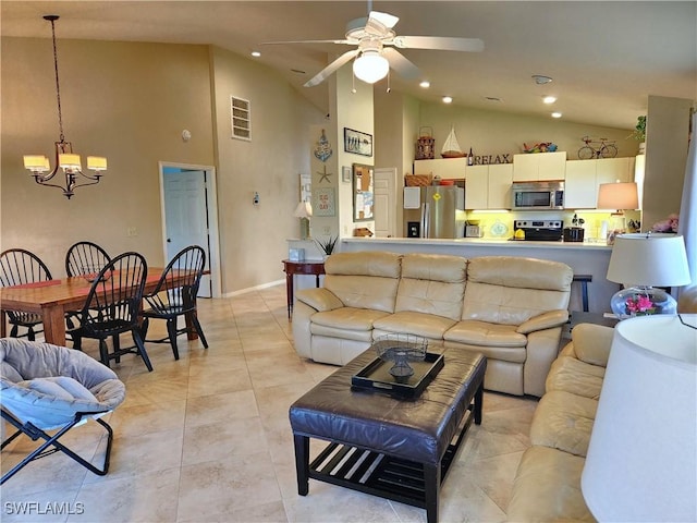 tiled living room with high vaulted ceiling and ceiling fan with notable chandelier