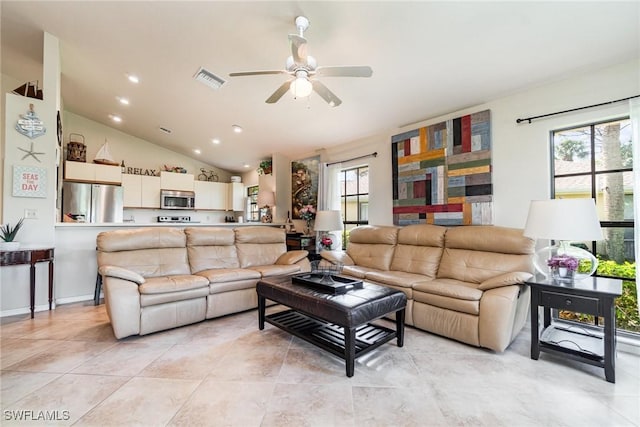 tiled living room with plenty of natural light, lofted ceiling, and ceiling fan