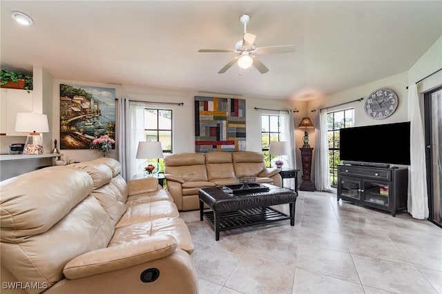 living room with ceiling fan, a healthy amount of sunlight, and light tile patterned floors