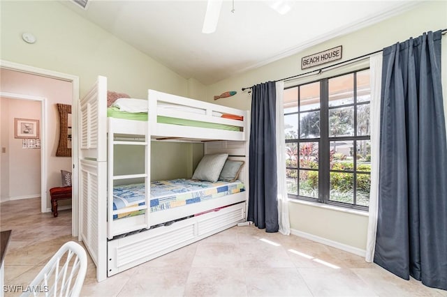 tiled bedroom featuring vaulted ceiling and ceiling fan