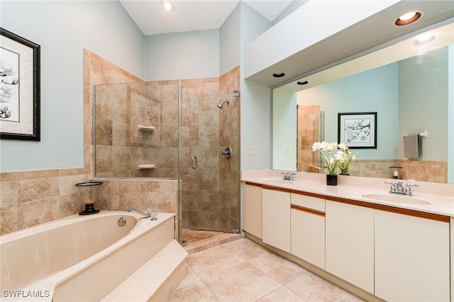 bathroom featuring tile patterned floors, vanity, and separate shower and tub