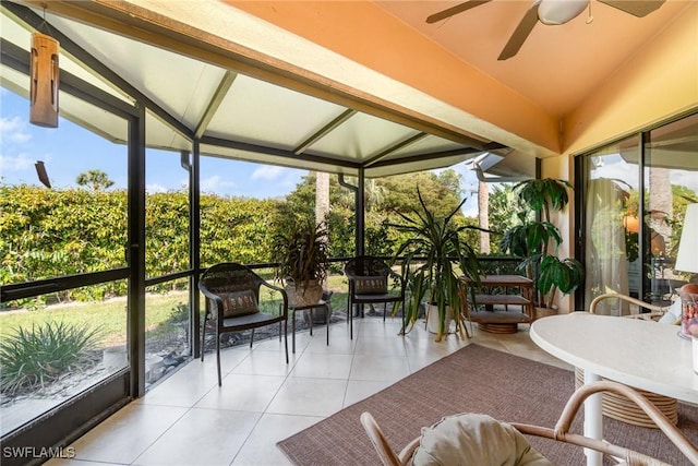 sunroom / solarium with ceiling fan and lofted ceiling